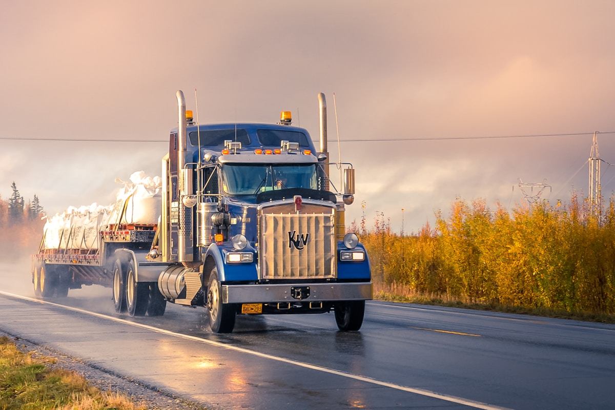 FLATLAND OILFIELD LLC tractor and trailer loaded for the next run